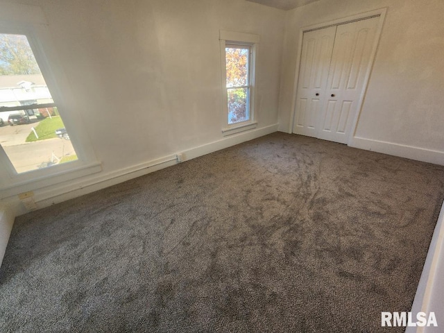 unfurnished bedroom with carpet and a closet