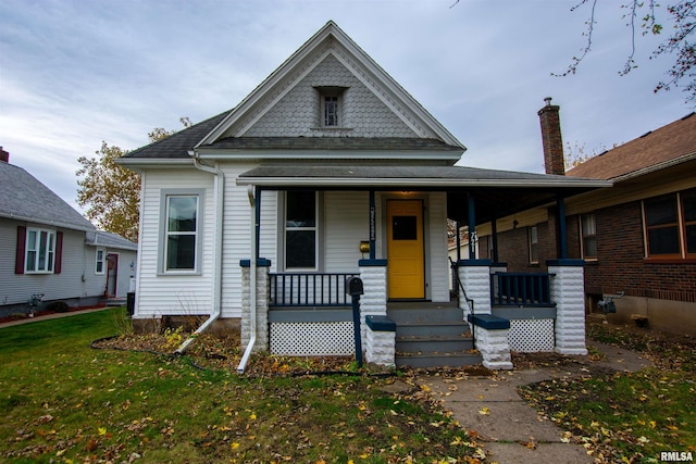 view of front of home with a porch and a front lawn