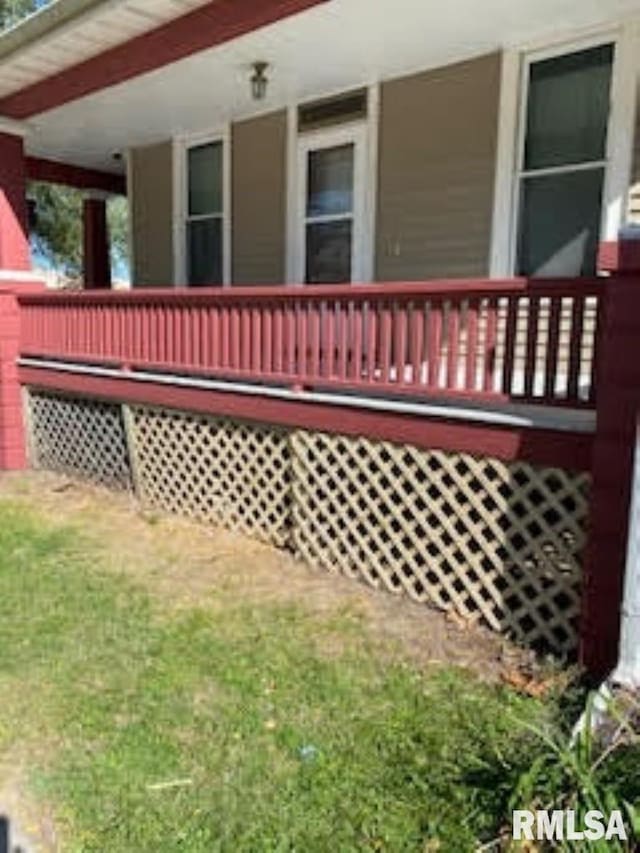 deck featuring a yard and a porch