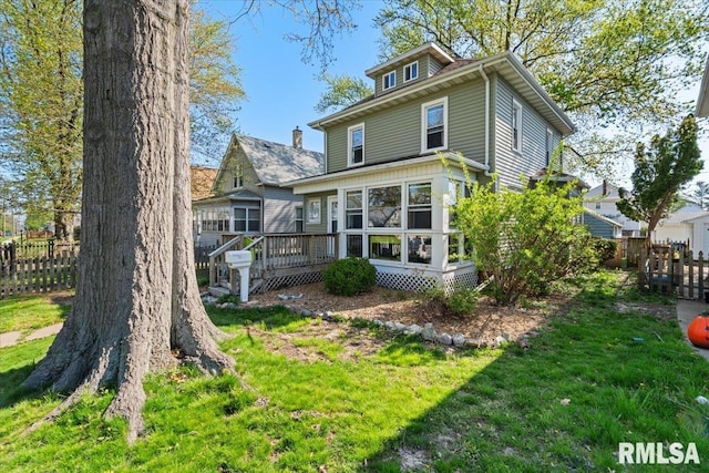 exterior space featuring a lawn and a wooden deck