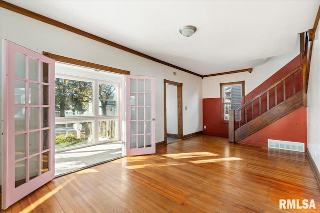 doorway to outside featuring hardwood / wood-style flooring and crown molding