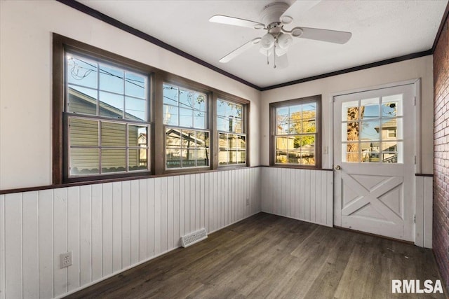 unfurnished sunroom featuring ceiling fan