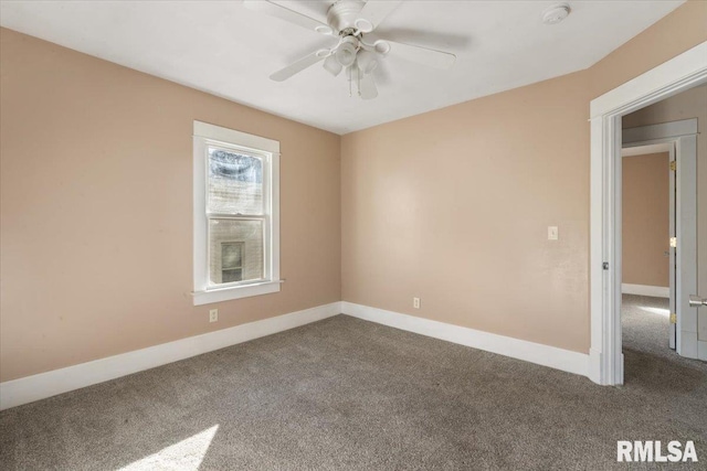 carpeted spare room with ceiling fan