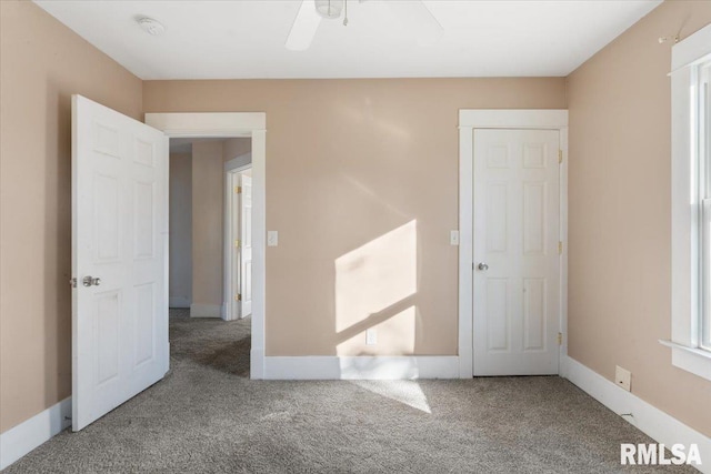 unfurnished bedroom with a closet, carpet flooring, and ceiling fan