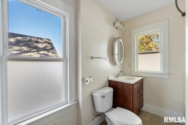 bathroom featuring tile patterned flooring, vanity, and toilet