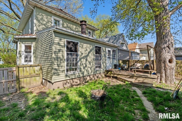 back of house featuring a wooden deck