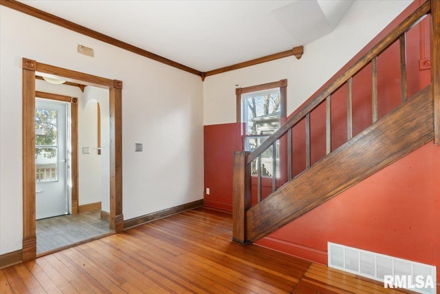 foyer with hardwood / wood-style floors and ornamental molding