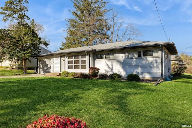 view of front of property with a front lawn and a garage