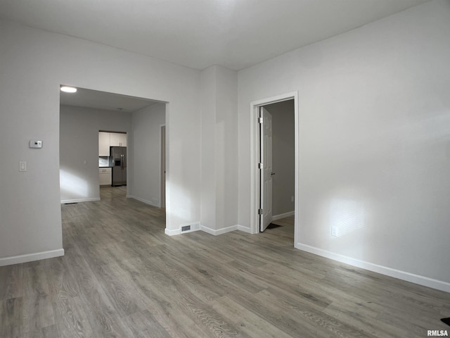 spare room featuring light hardwood / wood-style floors