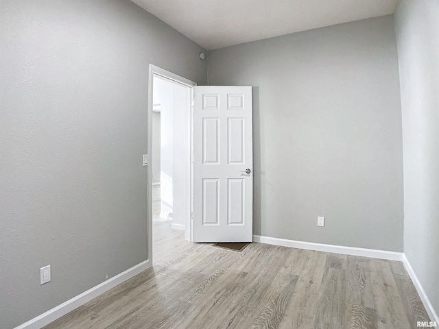 spare room with light hardwood / wood-style flooring