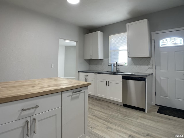 kitchen featuring white cabinets, dishwasher, backsplash, and sink