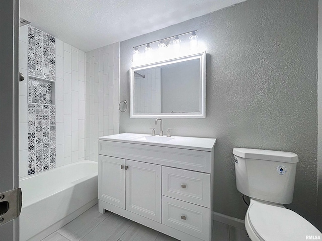 full bathroom featuring toilet, vanity, a textured ceiling, and tiled shower / bath combo