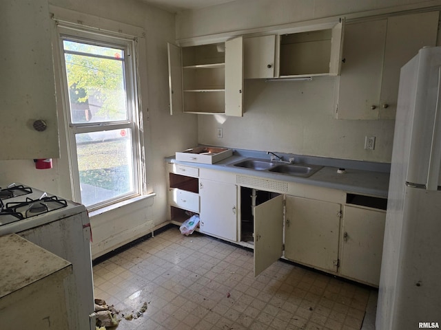 kitchen featuring white cabinetry, white appliances, and sink