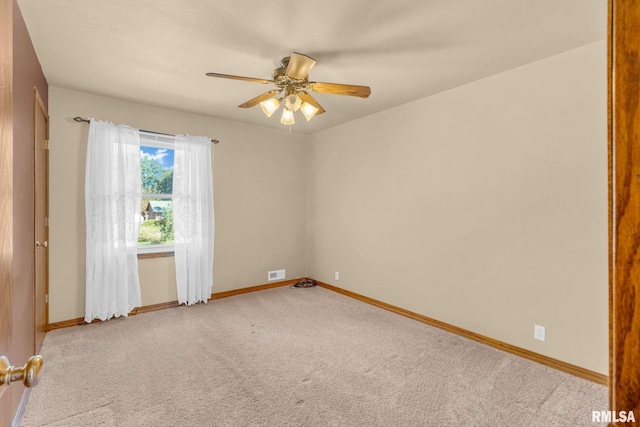 carpeted empty room featuring ceiling fan