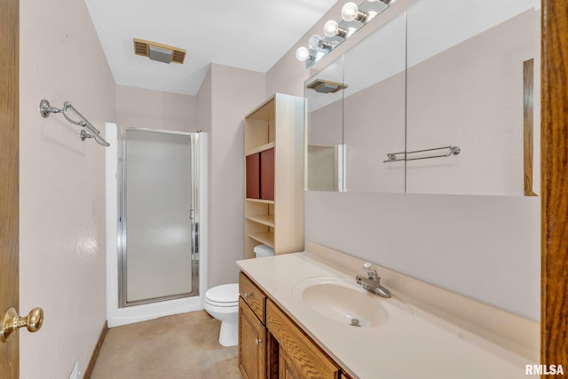 bathroom with vanity, toilet, and a shower with door