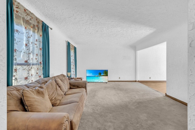 carpeted living room featuring a textured ceiling