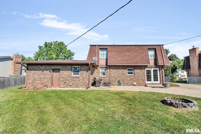 107 Hilltop St, Colona, IL 61241 - back of property with a fire pit, a patio, and brick siding