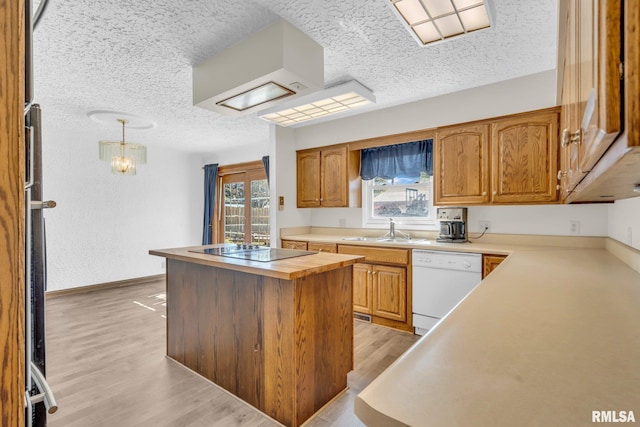 107 Hilltop St, Colona, IL 61241 - kitchen featuring black electric stovetop, dishwasher, a sink, light wood finished floors, and a kitchen island