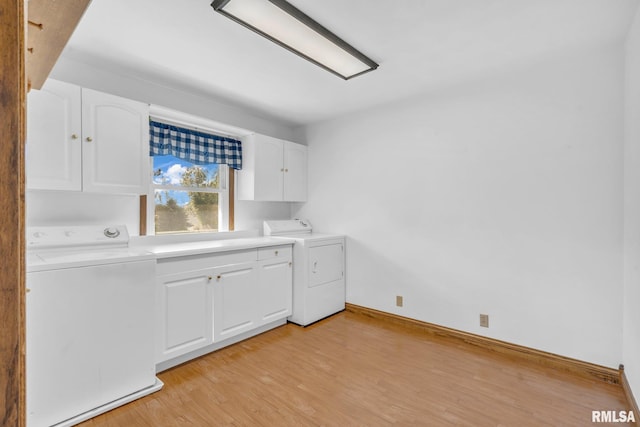 washroom with cabinets, washer and dryer, and light wood-type flooring