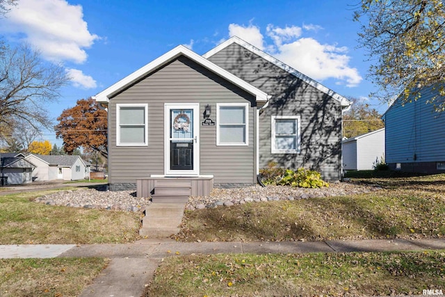 bungalow-style house featuring a front yard