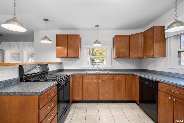 kitchen featuring black appliances, pendant lighting, sink, and light tile patterned floors