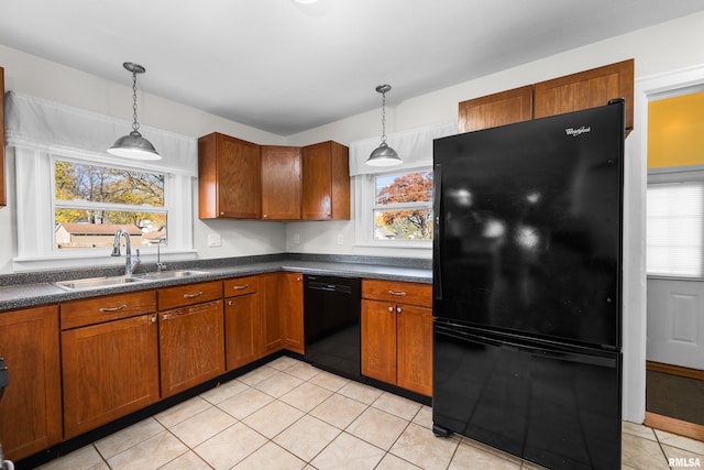 kitchen with black appliances, decorative light fixtures, a wealth of natural light, and sink