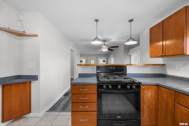 kitchen with ceiling fan, black range with gas cooktop, light tile patterned floors, and hanging light fixtures