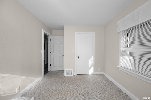 unfurnished bedroom with light carpet