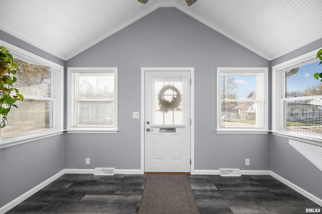 foyer entrance with dark hardwood / wood-style flooring, vaulted ceiling, and ceiling fan