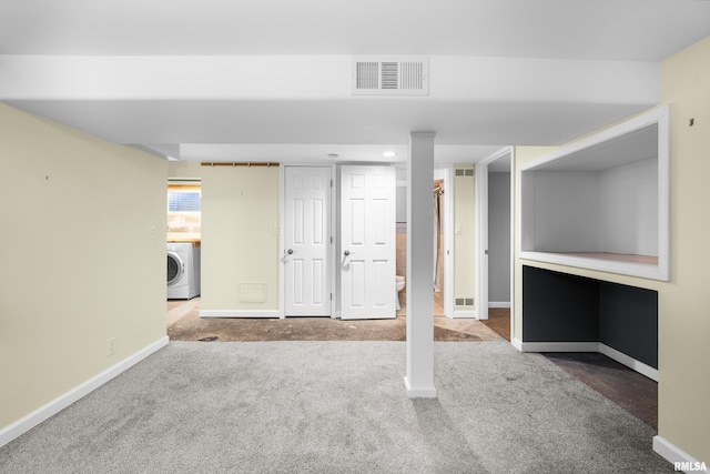 basement featuring carpet floors and washer / clothes dryer