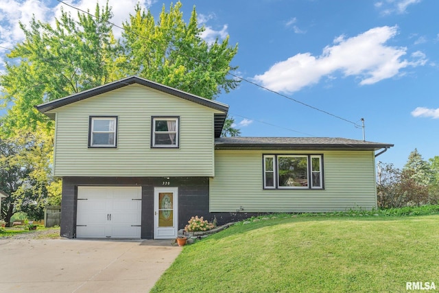 split level home featuring a front lawn and a garage