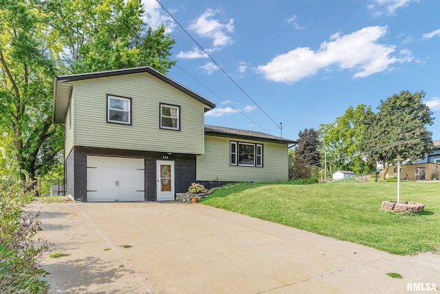 tri-level home featuring a garage and a front yard