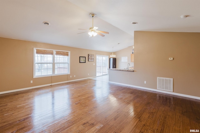 spare room featuring ceiling fan, wood-type flooring, sink, and vaulted ceiling