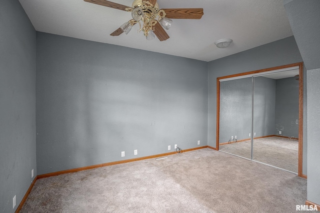 unfurnished bedroom with ceiling fan, carpet floors, and a closet