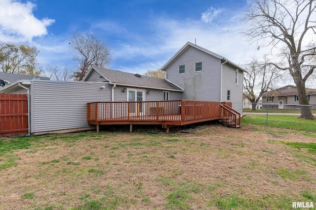 back of house featuring a deck and a yard