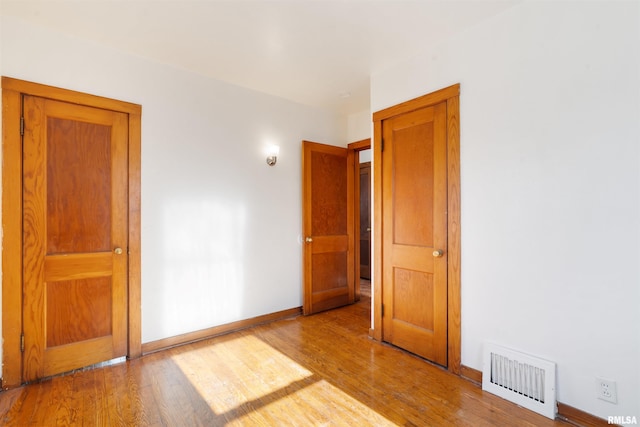 spare room featuring light wood-type flooring