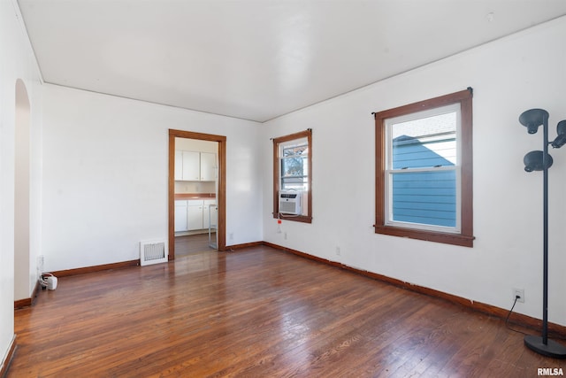 spare room featuring dark wood-type flooring and cooling unit