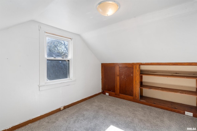 bonus room featuring vaulted ceiling and light carpet