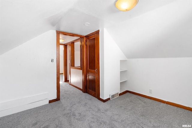 bonus room with carpet floors and lofted ceiling