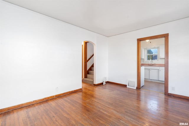 empty room featuring dark hardwood / wood-style flooring and sink