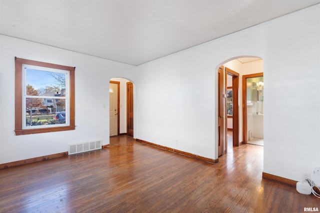 unfurnished room with dark wood-type flooring