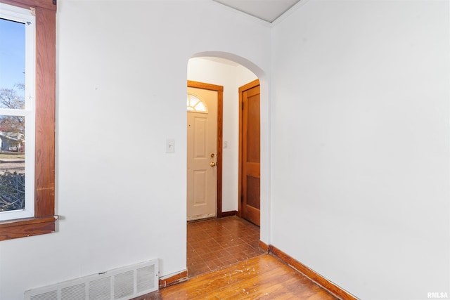 corridor featuring light hardwood / wood-style floors and crown molding