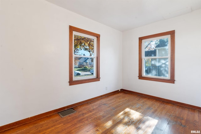 unfurnished room with wood-type flooring