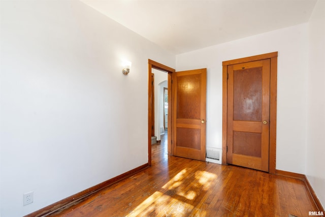 spare room with hardwood / wood-style flooring