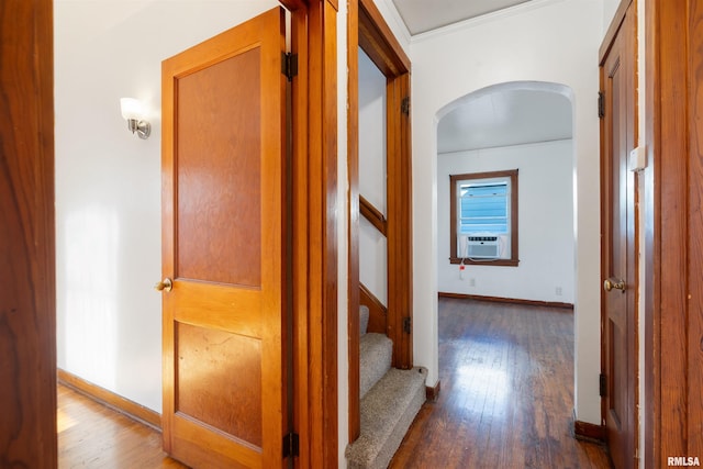 hall with dark wood-type flooring, cooling unit, and ornamental molding