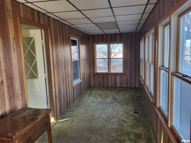 unfurnished sunroom with a drop ceiling