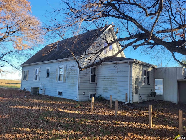 view of side of home featuring central AC unit