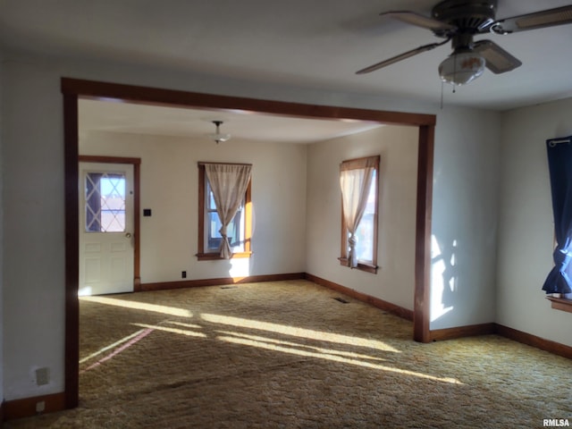 empty room featuring carpet floors and ceiling fan