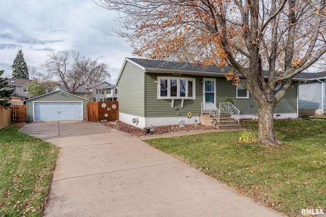 view of front of home with an outbuilding, a front yard, and a garage