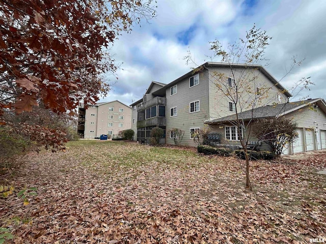 rear view of property featuring a garage